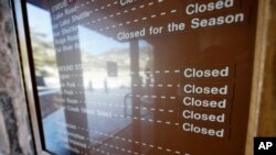 Sign inside the main visitors center notes that campgrounds are closed at Rocky Mountain National Park, Dec. 22, 2018, in Estes Park, Colorado. 