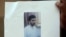  Indian man holds a copy of handout pictures released by the police showing Indian Mujahideen operative and alleged mastermind of the July 2011 Mumbai serial blasts, Yasin Bhatkal, at a press conference in Mumbai.