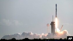 FILE - A Falcon 9 SpaceX rocket with a payload of approximately 60 satellites for SpaceX's Starlink broadband network lifts off from Pad 39A at the Kennedy Space Center in Cape Canaveral, Fla., March 18, 2020.