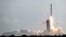 FILE - A Falcon 9 SpaceX rocket with a payload of approximately 60 satellites for SpaceX's Starlink broadband network lifts off from Pad 39A at the Kennedy Space Center in Cape Canaveral, Fla., March 18, 2020.