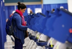 FILE - A young voter casts her ballot during early voting in Chicago, Illinois, Oct. 14, 2016.