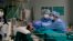 Medical staff tend to a patient in the emergency COVID-19 ward at the San Carlo Hospital in Milan, Italy, April 16, 2020.