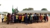 The principal of Government Secondary School, Tudun Wada, announcing the closure of schools to students at the assembly ground following an order by the Nigerian Government amid fears of the spreading of the COVID-19, in Abuja, March 20, 2020.