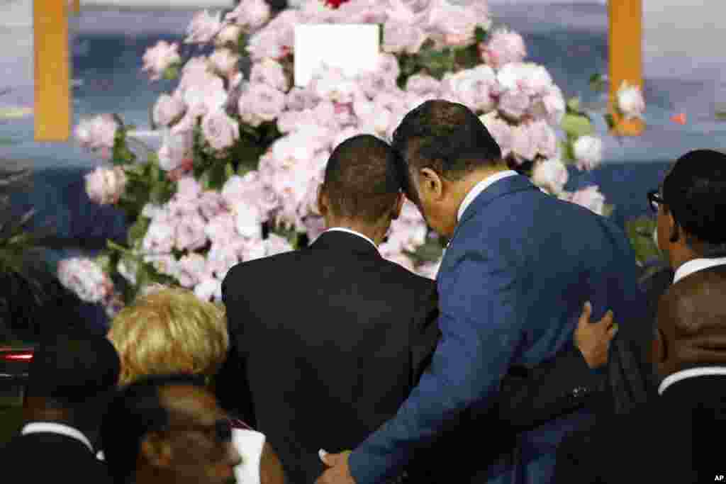 Rev. Jesse Jackson, right, consoles a family member as they pause at the casket of Aretha Franklin during her funeral service at Greater Grace Temple in Detroit, Aug. 31, 2018.