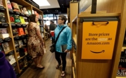 Customers browse the aisles at the Amazon Books store in Seattle, Nov. 3, 2015.