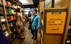Customers browse the aisles at the Amazon Books store in Seattle, Nov. 3, 2015.