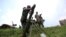  M23 rebel fighter loads an 82mm mortar bomb at their defense position in Karambi, eastern Democratic Republic of Congo (DRC) in north Kivu province, near the border with Uganda, July 12, 2012. 