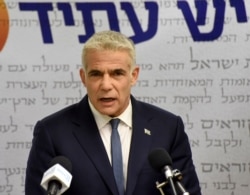 FILE - Yair Lapid delivers a statement to the press in the Knesset, in Jerusalem, May 31, 2021.