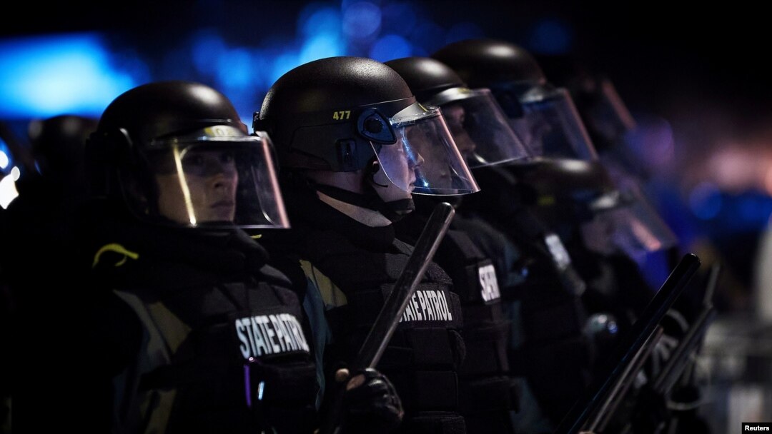 FILE - Police officers stand in the line in riot gear during protests against police brutality, in Minneapolis, Minnesota, May 28, 2020.