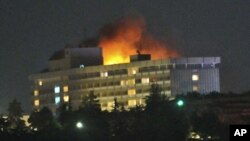 Smoke and flames light up the night from a blaze at the Intercontinental hotel after an attack on the hotel by Taliban fighters and a response by Afghan security forces backed by NATO helicopters in Kabul, June 29, 2011