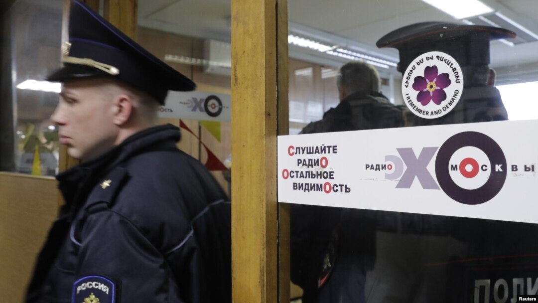 Policemen work inside the office of Russian radio station Ekho Moskvy, after an intruder attacked the station's anchor Tatyana Felgengauer in Moscow, Russia, Oct. 23, 2017. 