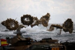 FILE - Amphibious assault vehicles of the South Korean Marine Corps fire smoke bombs during a U.S.-South Korea joint landing operation drill as a part of the two countries' annual military training in Pohang, South Korea, April 2, 2017.