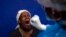 FILE - A throat swab is taken from a patient to test for COVID-19 at a facility in Soweto, South Africa, Dec. 2, 2021.