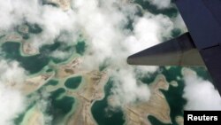 Lagoons can be seen from a plane as it flies above Kiritimati Island, part of the Pacific Island nation of Kiribati, April 5, 2016.