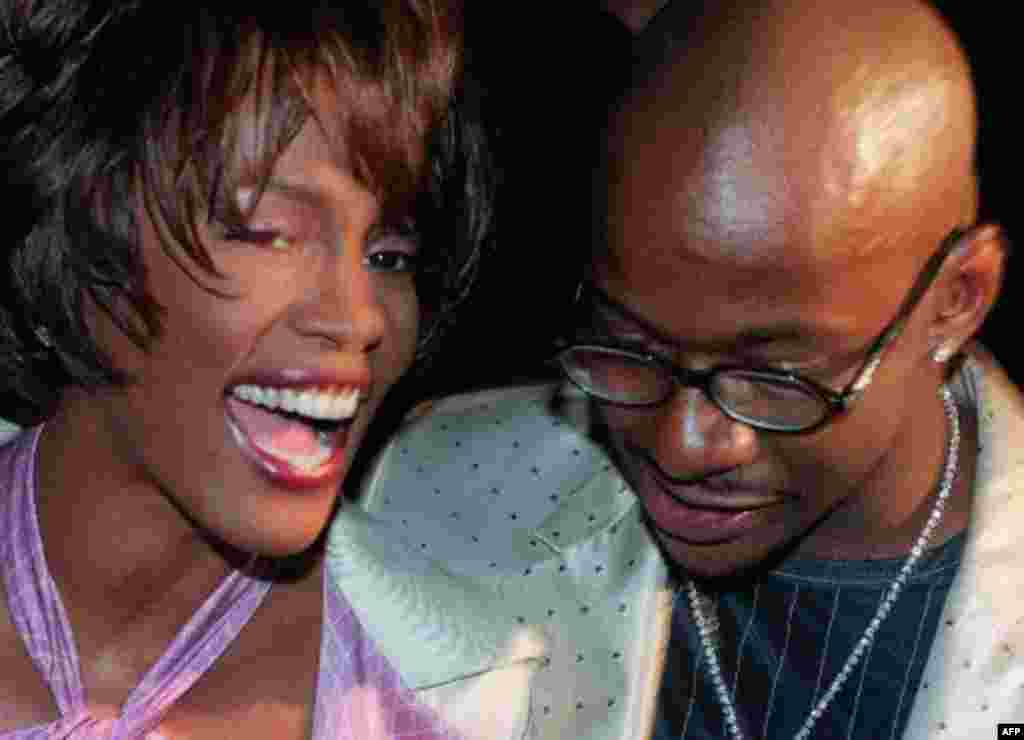 Whitney Houston and her husband Bobby Brown arrive for the Versace Fall 1998 fashion show in New York Saturday, March 28, 1998. (AP Photo/Mark Lennihan)