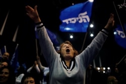 A supporter reacts following the announcement of exit polls in Israel's elections at Israeli Prime Minister Benjamin Netanyahu's Likud party headquarters in Tel Aviv, Israel, March 2, 2020.