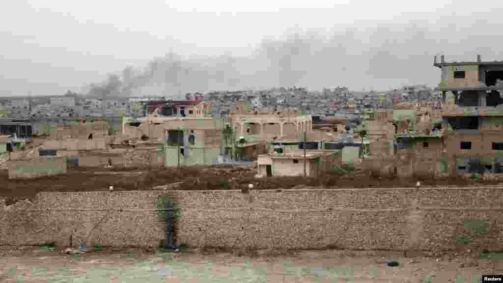 Smoke rises in Karm Qasr neighborhood in Aleppo, Jan. 26, 2014.