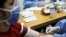 FILE PHOTO: Medical workers take blood samples from a man for a coronavirus disease (COVID-19) rapid test due to the COVID-19 outbreak in Caracas, Venezuela, April 15, 2020.