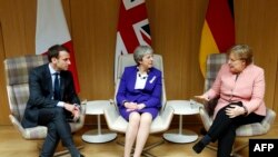 Emmanuel Macron, Theresa May, Angela Merkel