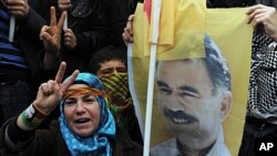 A demonstrator holds a poster of jailed Kurdish rebel leader Abdullah Ocalan in Istanbul, April 19, 2011