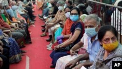 People wait to receive COVID-19 vaccine in Mumbai, India, April 29, 2021.
