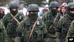 Pro-Russian soldiers guard Ukraine's infantry base in Perevalne, Ukraine, Tuesday, March 4, 2014. 