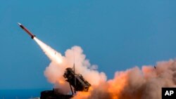FILE - German soldiers fire the Patriot weapons system at the NATO Missile Firing Installation, in Chania, Greece, Nov. 8, 2017. The Pentagon says the U.S. aims to move a Patriot missile battery into the Middle East region to counter threats from Iran. 