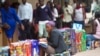 FILE - A bag vendor waits for clients on a street in Harare, Zimbabwe, Dec. 20, 2016. The economy of the once-prosperous southern African country has long been ailing.