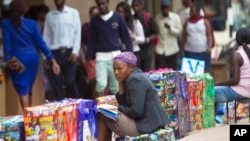 FILE - A bag vendor waits for clients on a street in Harare, Zimbabwe, Dec. 20, 2016. The economy of the once-prosperous southern African country has long been ailing.