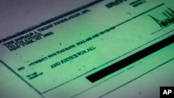 A Sept. 15, 2016 copy provided by the New York state attorney general shows a $25,000 check from the Donald J. Trump Foundation to And Justice For All signed by Donald J. Trump. The $25,000 check was sent from his personal foundation to a political committee supporting Florida Attorney General Pam Bondi. Charities are barred from engaging in political activities. 