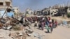 Displaced Palestinians fleeing Israeli military operations in Beit Lahia in the northern Gaza Strip walk along the Salah al-Din main road in eastern Gaza City on Oct. 22, 2024. A U.N. report says the war has set back development in Gaza by seven decades and multiple generations.