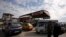 FILE - Cars stand in line at a gasoline station as they wait to fuel up in Aleppo, Syria, April 11, 2019.
