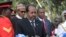 Somalia's President Hassan Sheikh Mohamud, center, lays a wreath as Kenya's President Uhuru Kenyatta, center right, and President Muhammadu Buhari of Nigeria, center left, stand behind at an interfaith memorial service honoring Kenyan soldiers killed whil