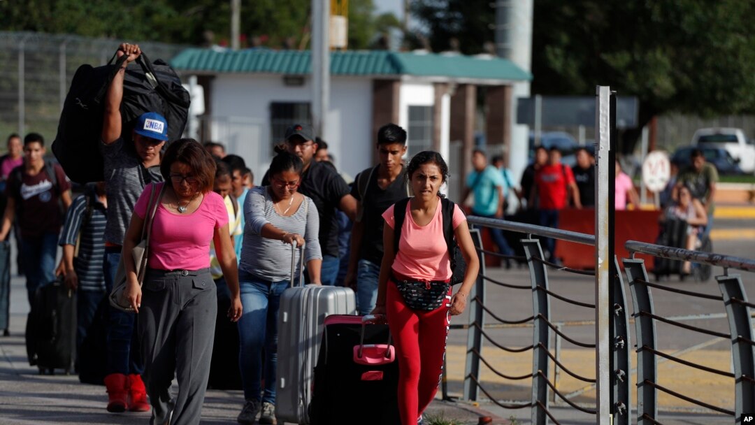Para pekerja asal Meksiko melintasi penyeberangan internasional Puerta Mexico menuju Brownsville, Texas di Amerika Serikat, untuk mencari pekerjaan musiman, di Matamoros, negara bagian Tamaulipas, Meksiko, 27 Juni 2020. 