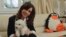 Argentine President Cristina Fernandez poses with her dog at the Olivos Presidential residence in Buenos Aires in this Nov. 18, 2013 handout supplied by the Argentine Presidency.