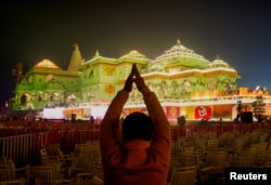 A Hindu devotee prays near the Lord Ram temple after its inauguration, in Ayodhya, India, January 22, 2024. (REUTERS/Adnan Abidi)