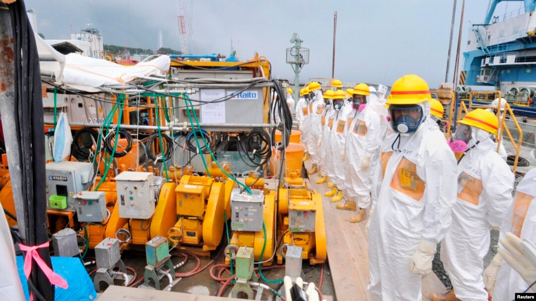 Members of a Fukushima prefecture panel, which monitors the safe decommissioning of the nuclear plant, inspect the construction site of the shore barrier, Aug. 6, 2013.