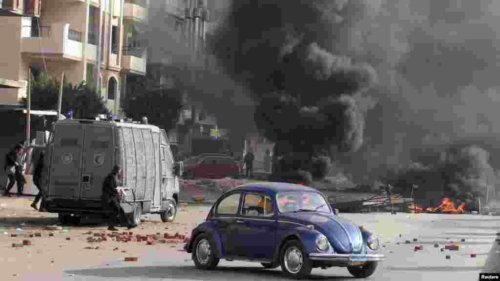 Smoke rises as Egyptian security forces clash with supporters of deposed Egyptian President Mohamed Morsi in Nasr City, Cairo, Jan. 8, 2014.