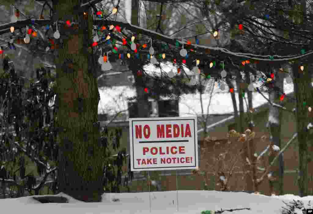 On the first anniversary of the Sandy Hook massacre, Newtown, Conn., a sign is posted under a Christmas tree, Dec. 14, 2013.