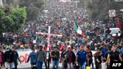 TOPSHOT - Migrants take part in a caravan towards the border with the United States in Tapachula, Chiapas State, Mexico, on Dec. 24, 2023.
