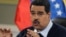 FILE - Venezuelan President Nicolas Maduro gestures during a news conference at Miraflores presidential palace in Caracas, Aug. 24, 2015.