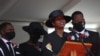 The former first lady of Haiti, Martine Moise, speaks during the funeral of her slain husband, former President Jovenel Moise, accompanied by her children in Cap-Haitien, Haiti, July 23, 2021.