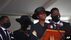 The former first lady of Haiti, Martine Moise, speaks during the funeral of her slain husband, former President Jovenel Moise, accompanied by her children in Cap-Haitien, Haiti, July 23, 2021.