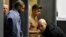 Bodyguards try to block the view of Canadian singer Justin Bieber as he goes through Wladyslaw Reymont Airport in Lodz following his concert March 25, 2013.