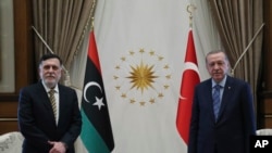 Turkey's President Recep Tayyip Erdogan, right, and Fayez Sarraj, the head of Libya's internationally-recognized government, speak prior to their talks in Ankara, Turkey, June 4, 2020. 