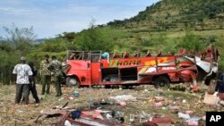 Kenyan police and other rescuers attend the scene of a bus crash near Kericho in western Kenya Wednesday, Oct. 10, 2018. 
