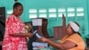 A woman votes in a referendum on whether to adopt a new constitution, in Libreville, Gabon, on Nov. 16, 2024.