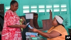 A woman votes in a referendum on whether to adopt a new constitution, in Libreville, Gabon, on Nov. 16, 2024.
