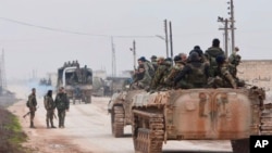 In this photo released by the Syrian official news agency SANA, government forces enter the village of Tel-Toukan, in Idlib province, northwest Syria, Feb. 5, 2020.