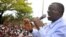 FILE - Uganda's main opposition leader and Inter Party flag bearer, Dr. Kiiza Besigye, addresses his supporters at Masaka Lyantonde, about 200 kms west of Kampala capital Uganda. Saturday, Nov. 6, 2010.
